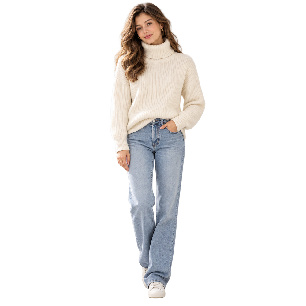 A woman modeling a cream ribbed turtleneck sweater and light-wash blue jeans against a plain white background.